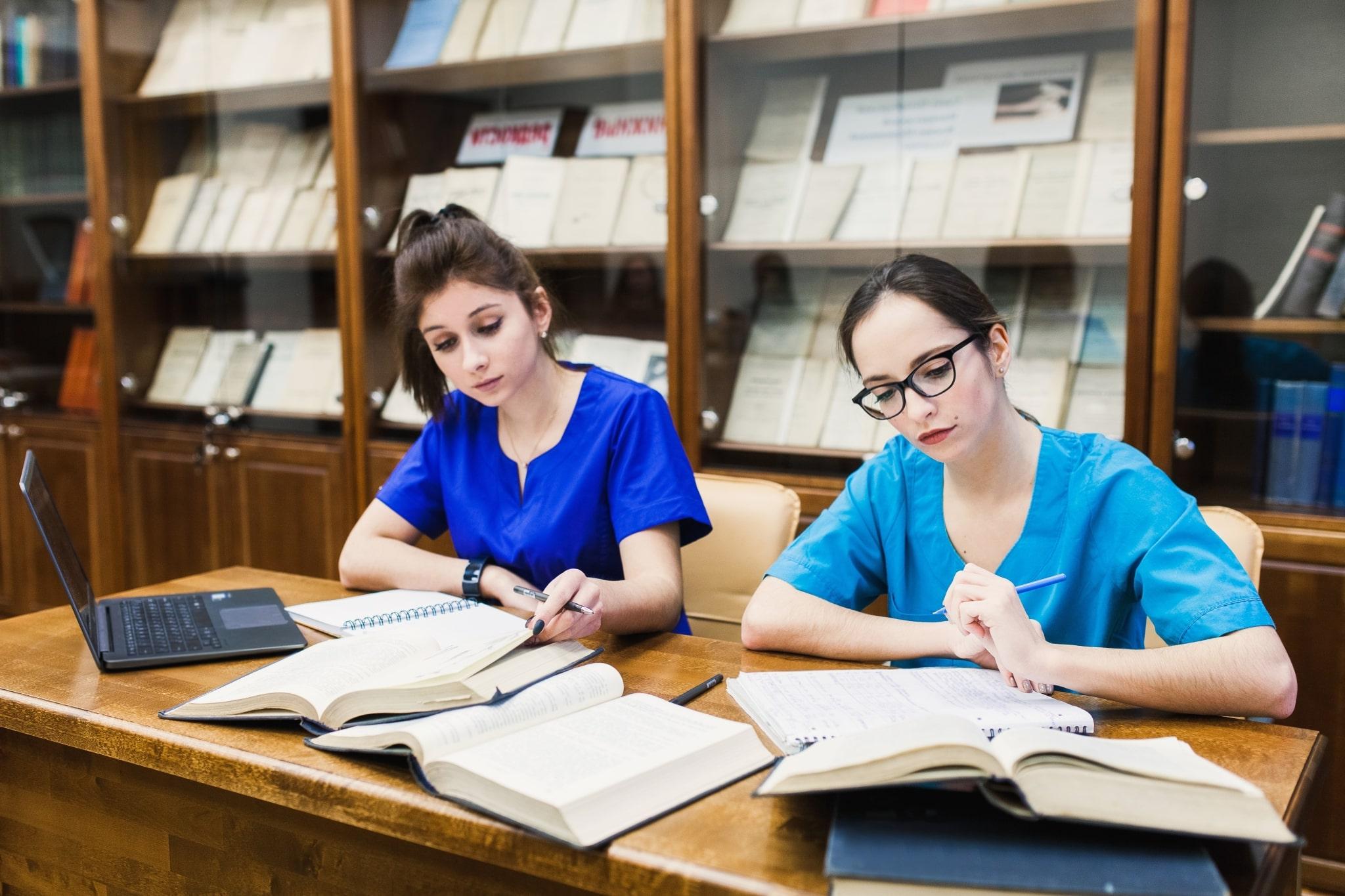 Medical students writing in notebooks