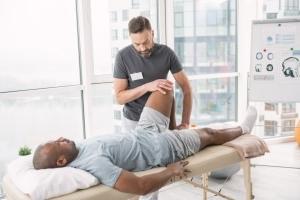 Physical therapy professional examining a patient